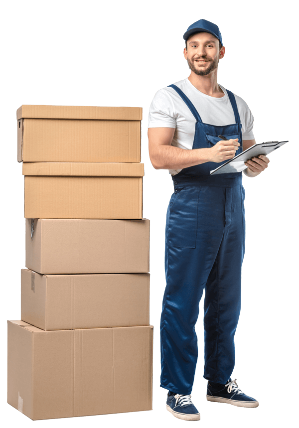 A man in overalls standing next to a stack of boxes.