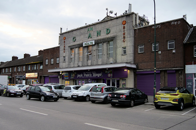 An Expert Removals brick building with cars parked in front of it.