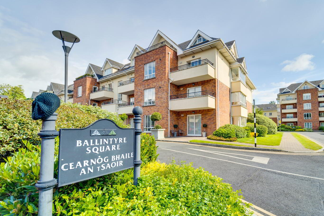 An apartment building with a sign in front of it advertising Expert Removals services.