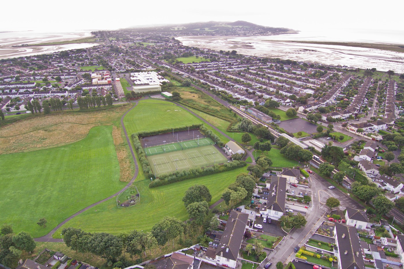 An aerial view of a soccer field surrounded by houses, showcasing the expertise of Expert Removals at handling residential relocations.