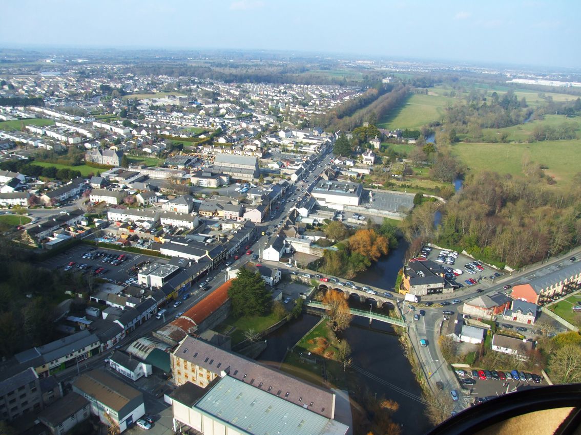 An expert aerial view of a town from a helicopter.