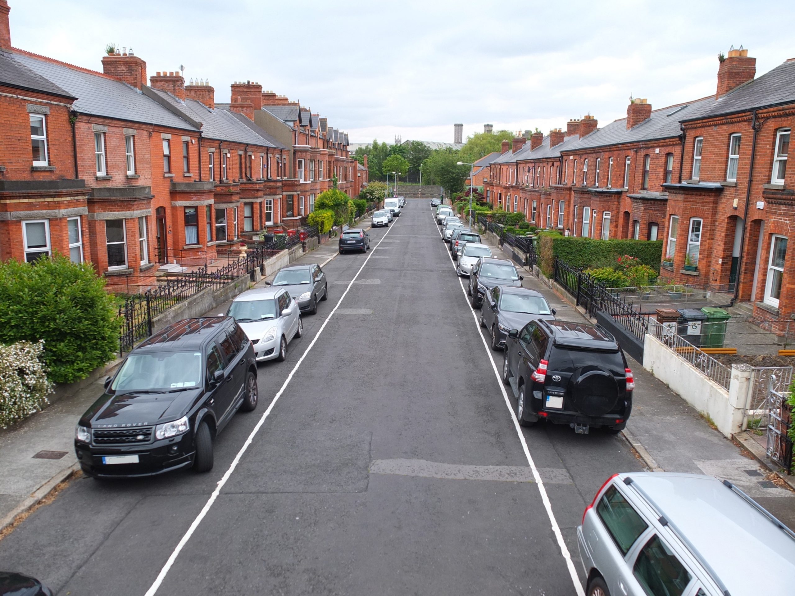 Expert Removals on a street with cars parked.