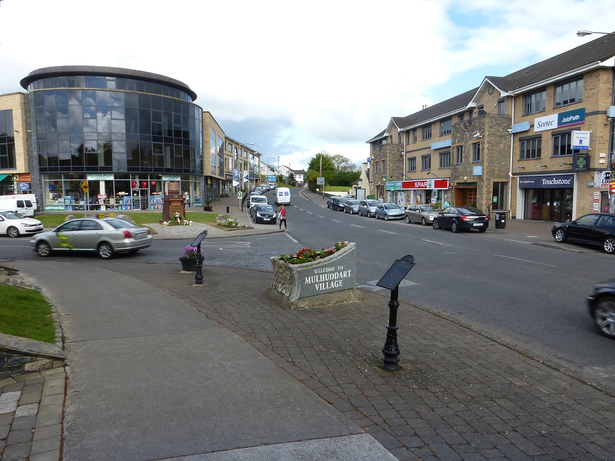 A street with cars parked on it near Expert Removals.