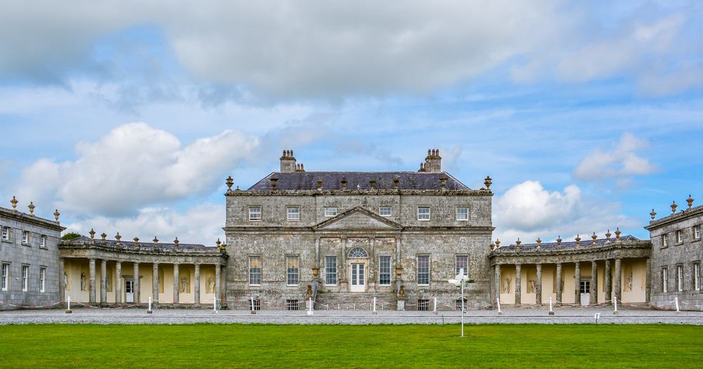 Expert Removals:
A spacious stone building stands majestically in the center of a serene grassy field.