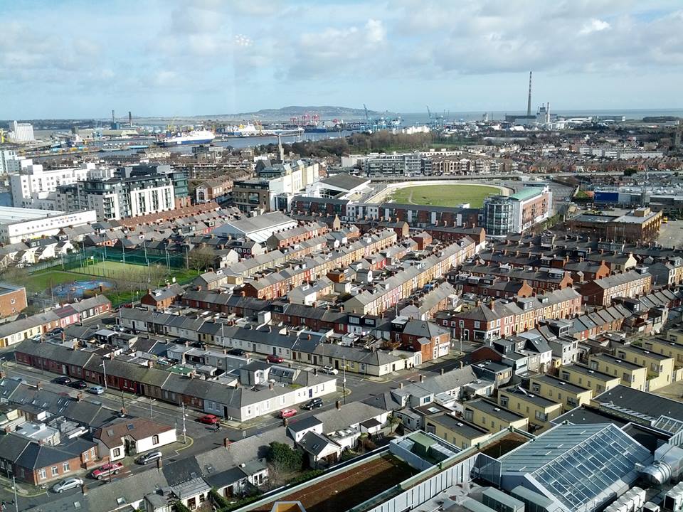 An expert view of a city from the top of a tall building.