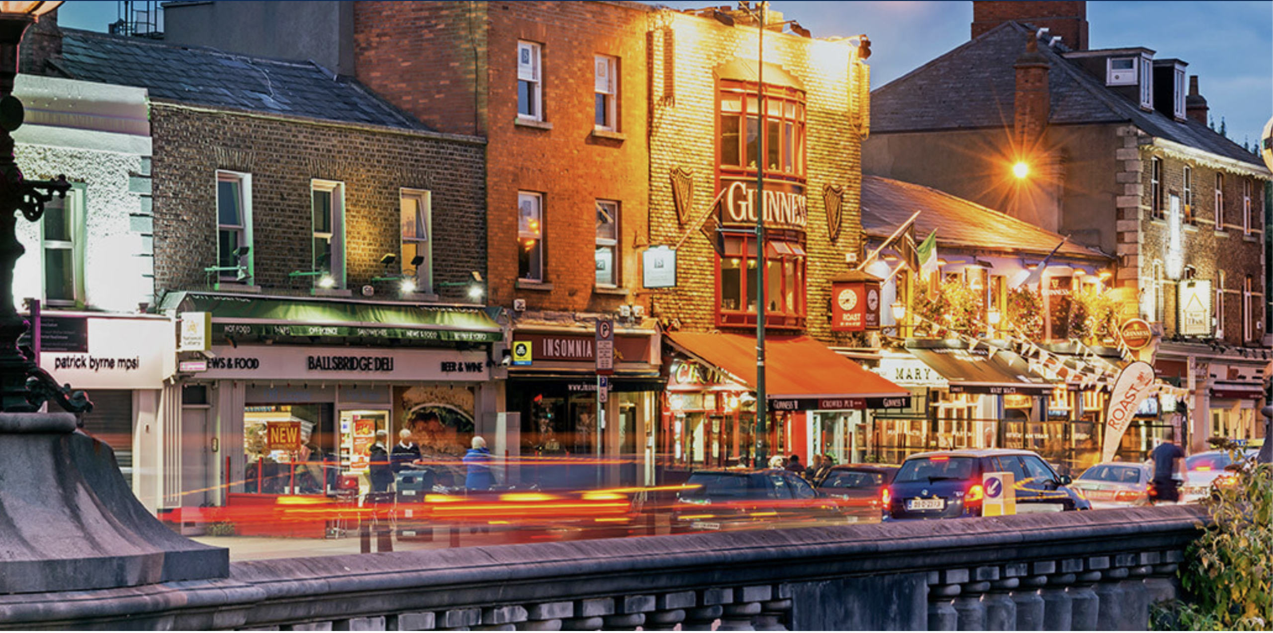 Expert Removals operates on a bustling street in Dublin at dusk.