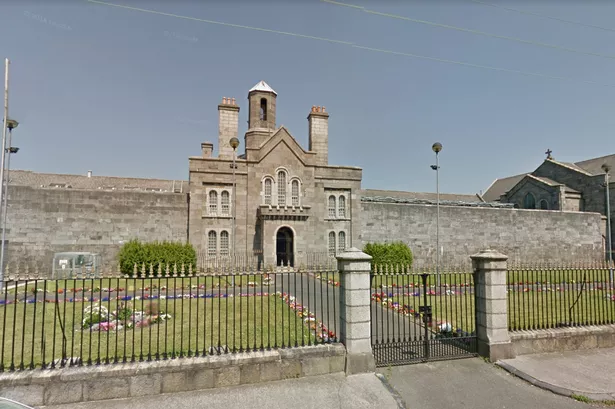 A stone building with a fence captured in Google Street View.