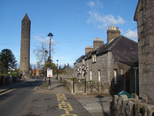 A street with houses and an expert removals clock tower.