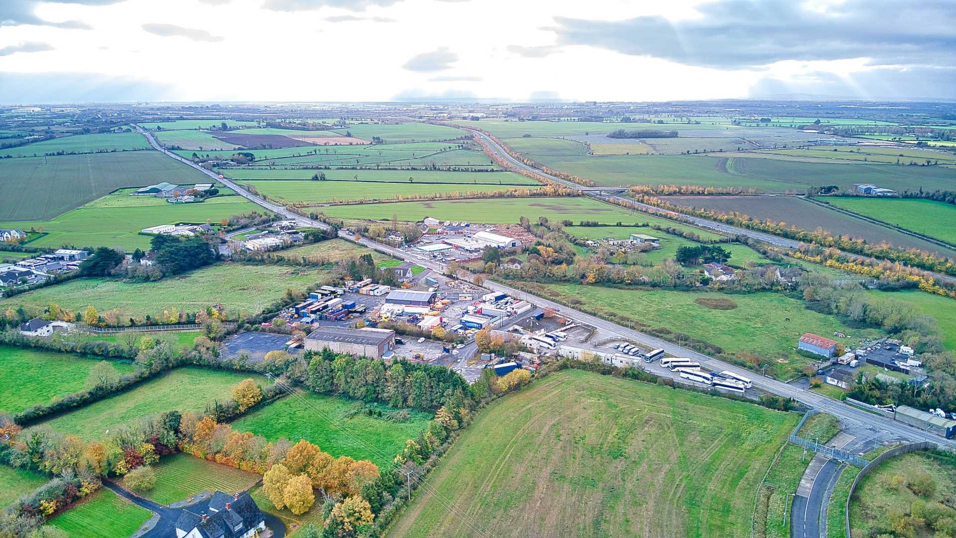 An aerial view of a rustic countryside with sprawling farmland.