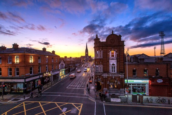 An aerial view of a city street at dusk, showcasing the hustle and bustle of urban life.