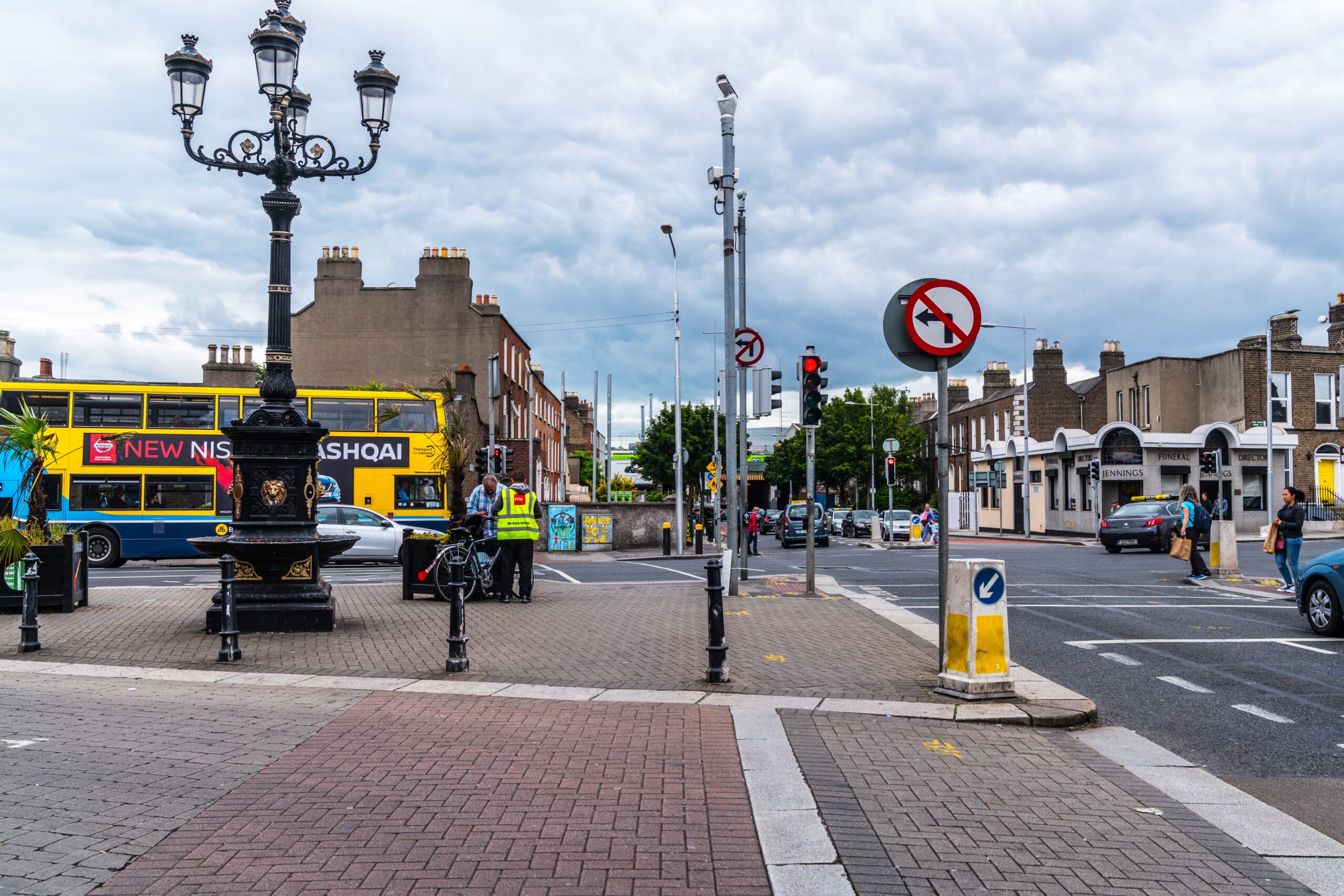 An Expert Removals double decker bus on a city street.