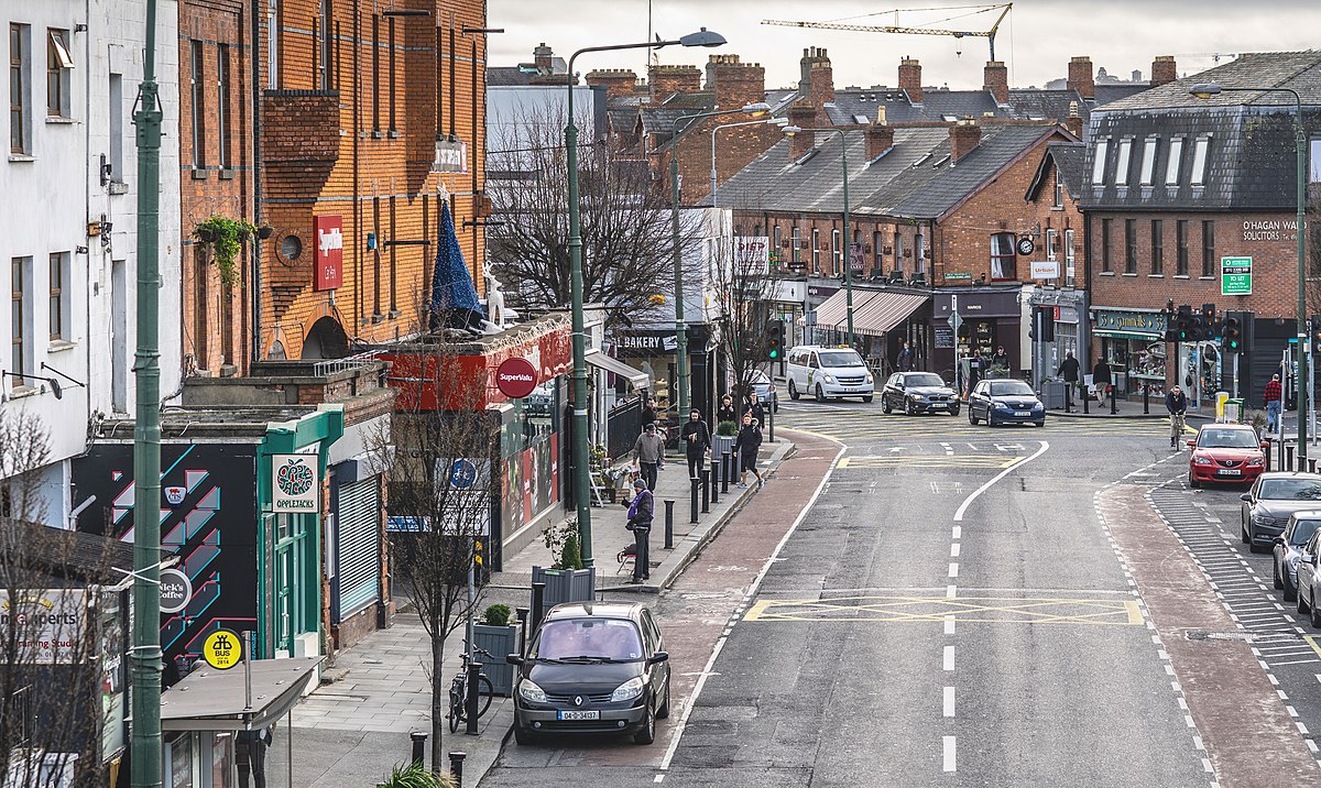 A city street with cars parked on it, where Expert Removals can efficiently assist with car relocation.