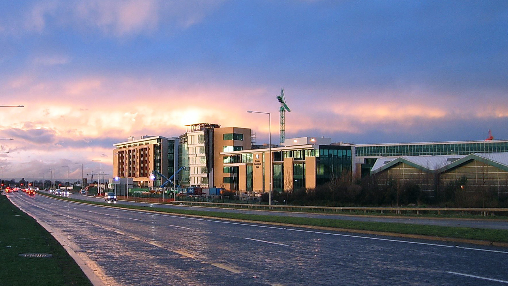 A building with a wet road beside it, expertly serviced by Expert Removals.