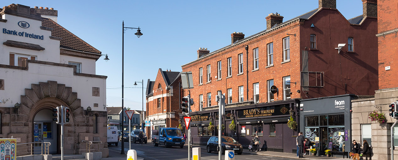 An Expert Removals' brick building on a busy city street.